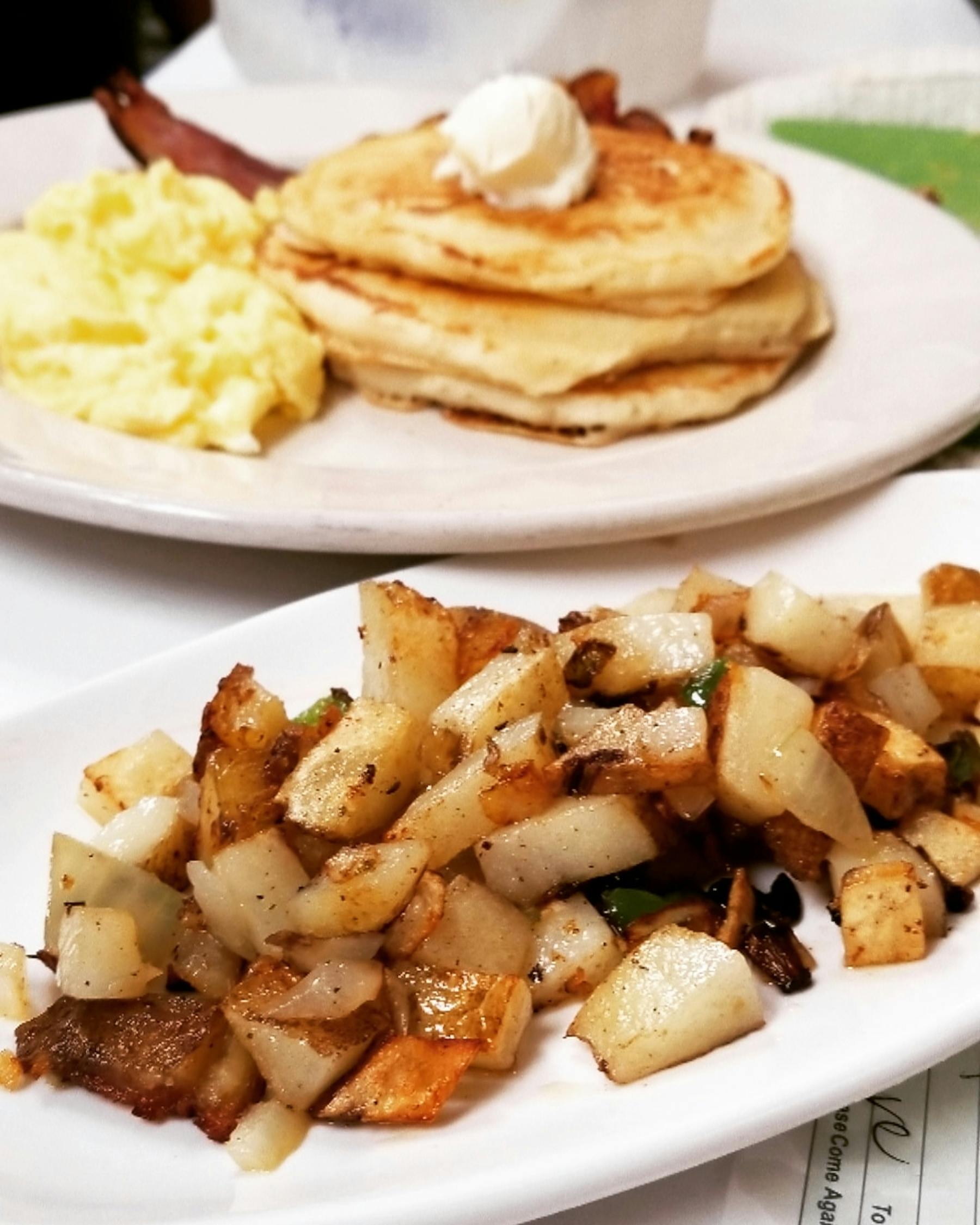 a pair of plates topped with bread and pancakes